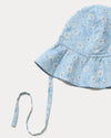 Early Sunday, Bonnie Hat Cap in Tonal Floral Blue color, made from Printed Tiny Swiss Dobby fabric, shown in a closeup flat-lay view