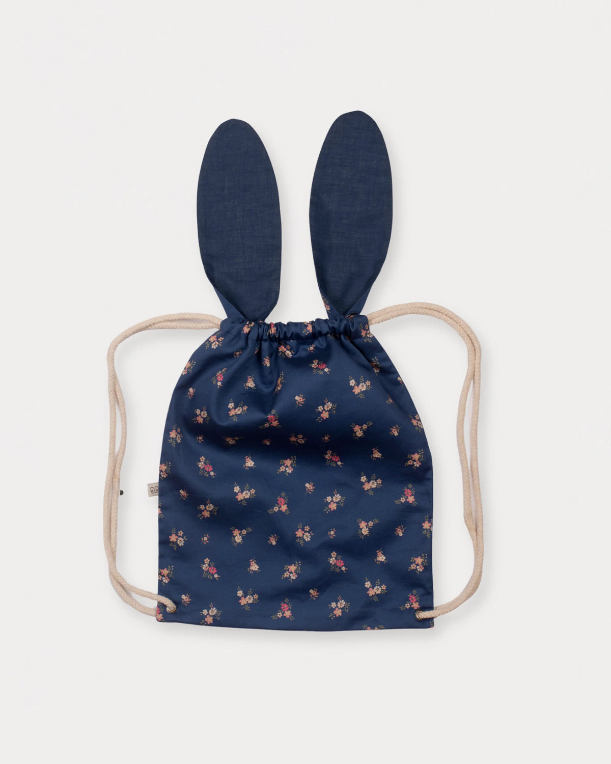 Early Sunday, Bunny Bag in Ditsy Bouquet Navy Blue, made from Printed Cotton Satin fabric, featuring a bunny-ear design with a drawstring closure, shown in a back flat-lay view