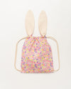 Early Sunday, Bunny Drawstring Backpack in Emma Floral Purple color, made from Organic Printed Cotton Cambric fabric, featuring a bunny-ear design with a drawstring closure, shown in a back flat-lay view