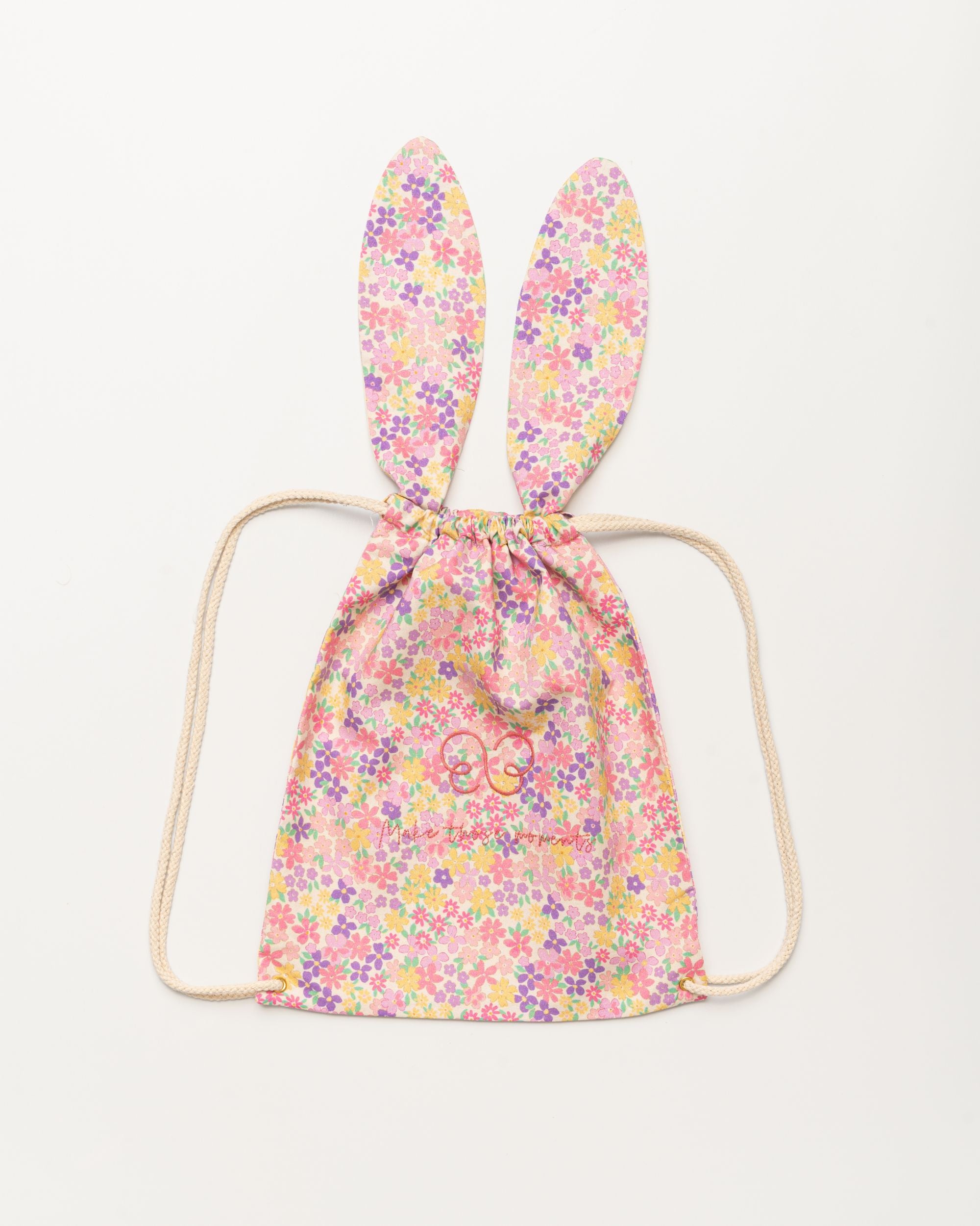 Early Sunday, Bunny Drawstring Backpack in Emma Floral Purple color, made from Organic Printed Cotton Cambric fabric, featuring a bunny-ear design with a drawstring closure, shown in a front flat-lay view