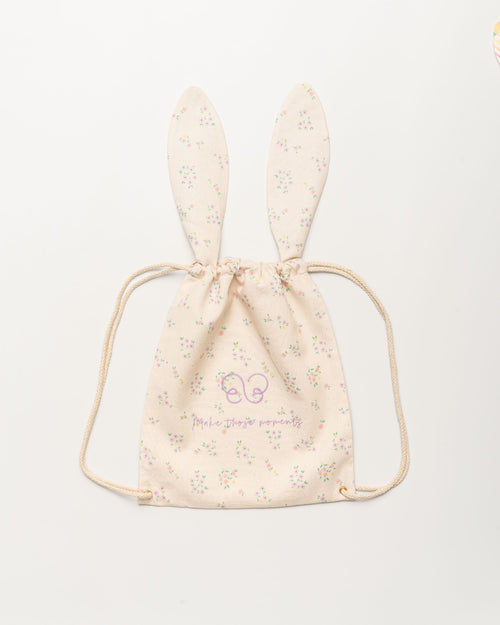 Early Sunday, Bunny Drawstring Backpack in Painted Bouquet print, made from Printed 70% Cotton, 30% Linen fabric, featuring a bunny-ear design with a drawstring closure, shown in a front flat-lay view