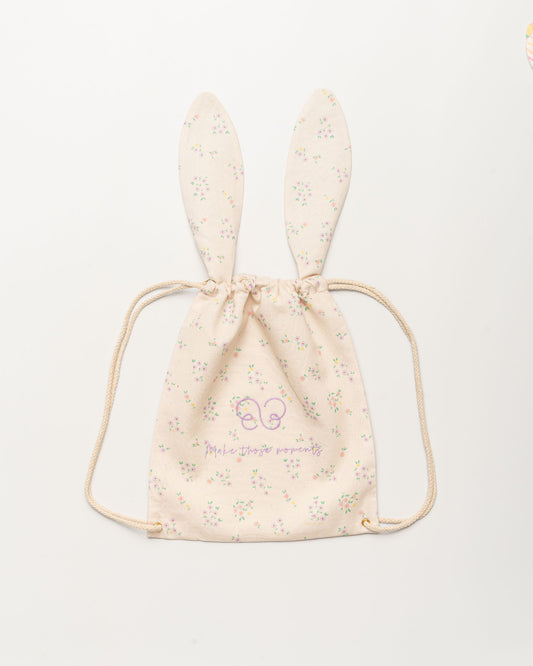 Early Sunday, Bunny Drawstring Backpack in Painted Bouquet print, made from Printed 70% Cotton, 30% Linen fabric, featuring a bunny-ear design with a drawstring closure, shown in a front flat-lay view