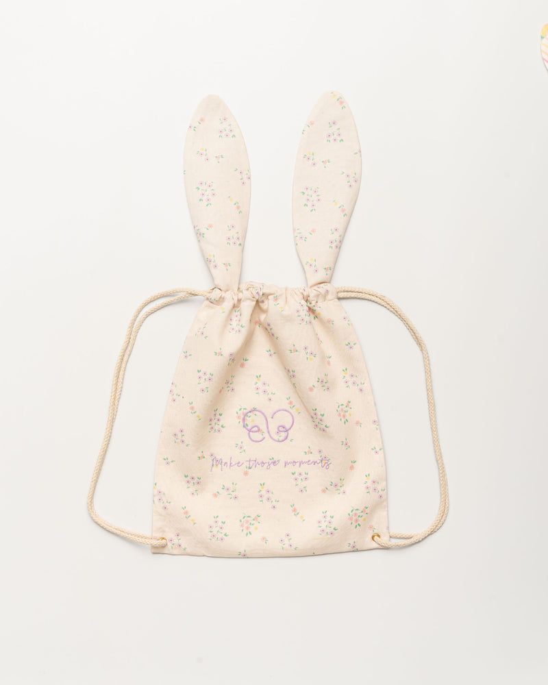 Early Sunday, Bunny Drawstring Backpack in Painted Bouquet print, made from Printed 70% Cotton, 30% Linen fabric, featuring a bunny-ear design with a drawstring closure, shown in a front flat-lay view