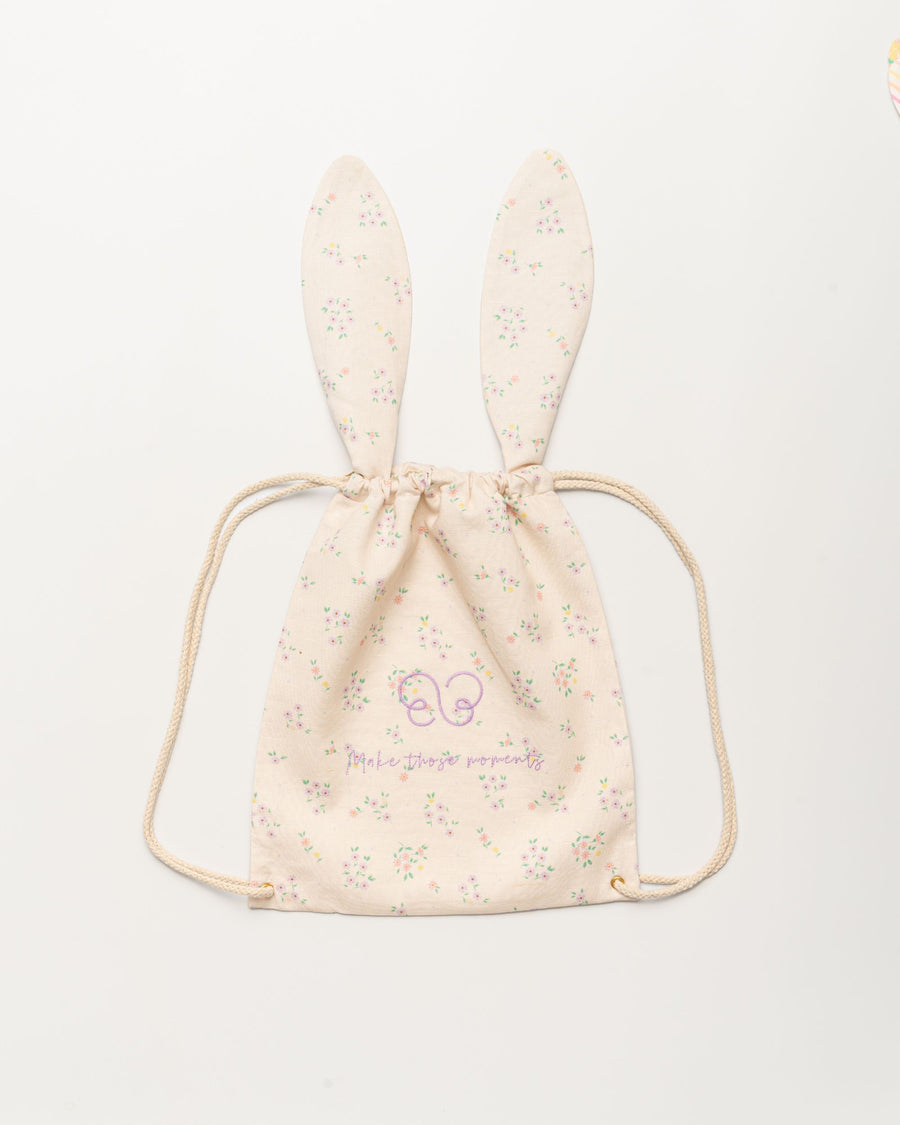Early Sunday, Bunny Drawstring Backpack in Painted Bouquet print, made from Printed 70% Cotton, 30% Linen fabric, featuring a bunny-ear design with a drawstring closure, shown in a front flat-lay view