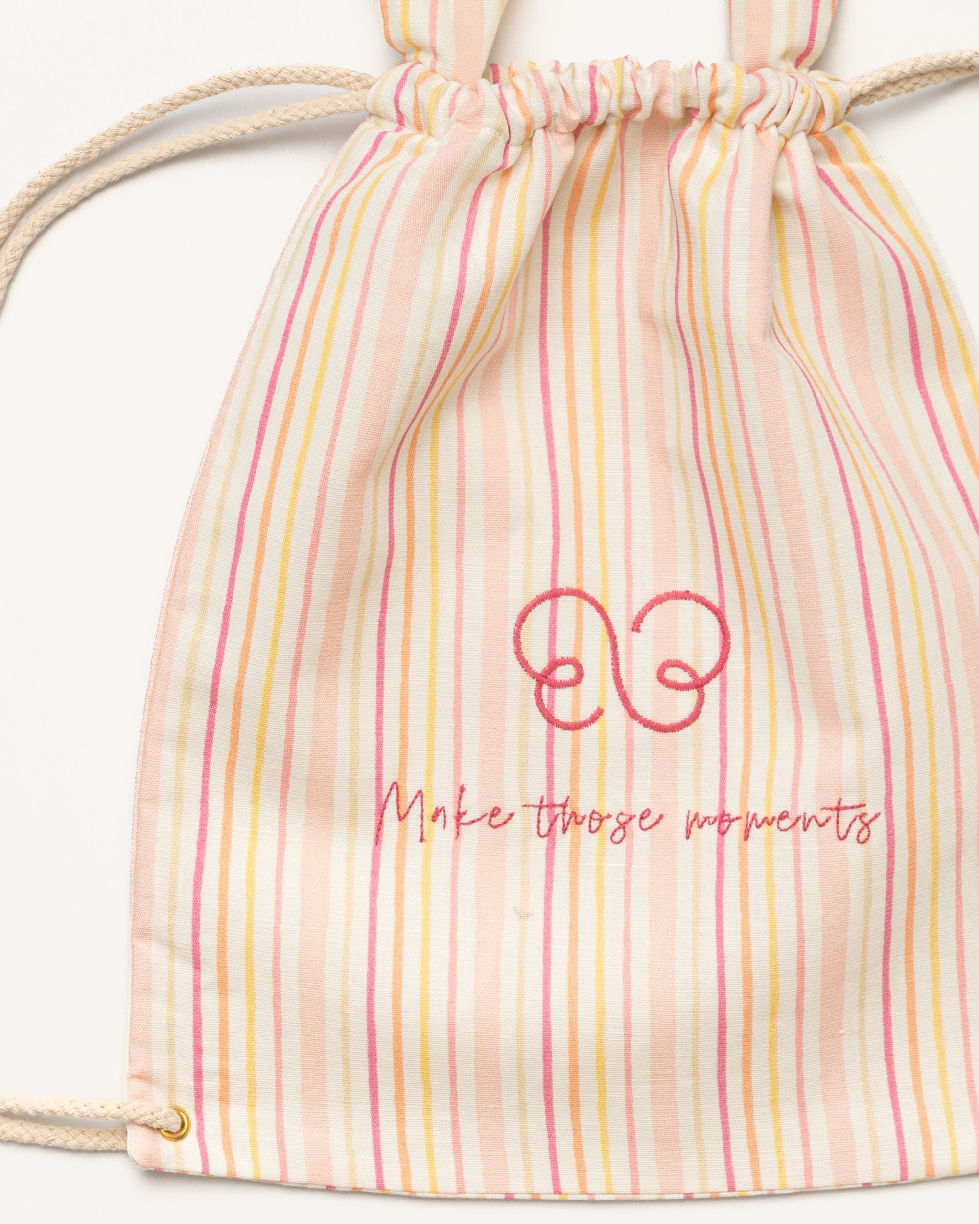 Early Sunday, Bunny Drawstring Backpack in Pink Stripes print, made from Printed 70% Cotton, 30% Linen fabric, featuring a bunny-ear design with a drawstring closure, shown in a closeup flat-lay view