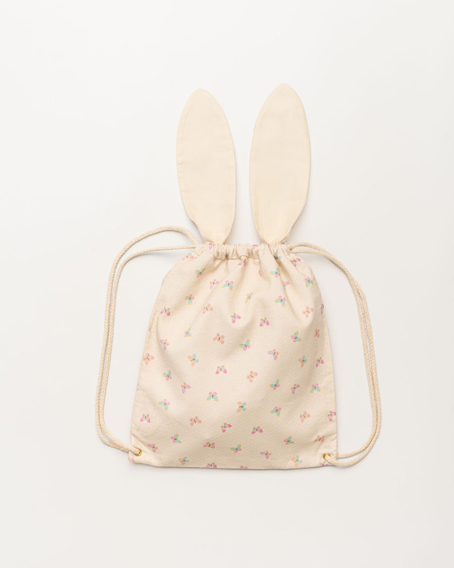 Early Sunday, Bunny Drawstring Backpack in Butterflies print, made from Printed Cotton Tiny Swiss Dobby fabric, featuring a bunny-ear design with a drawstring closure, shown in a back flat-lay view
