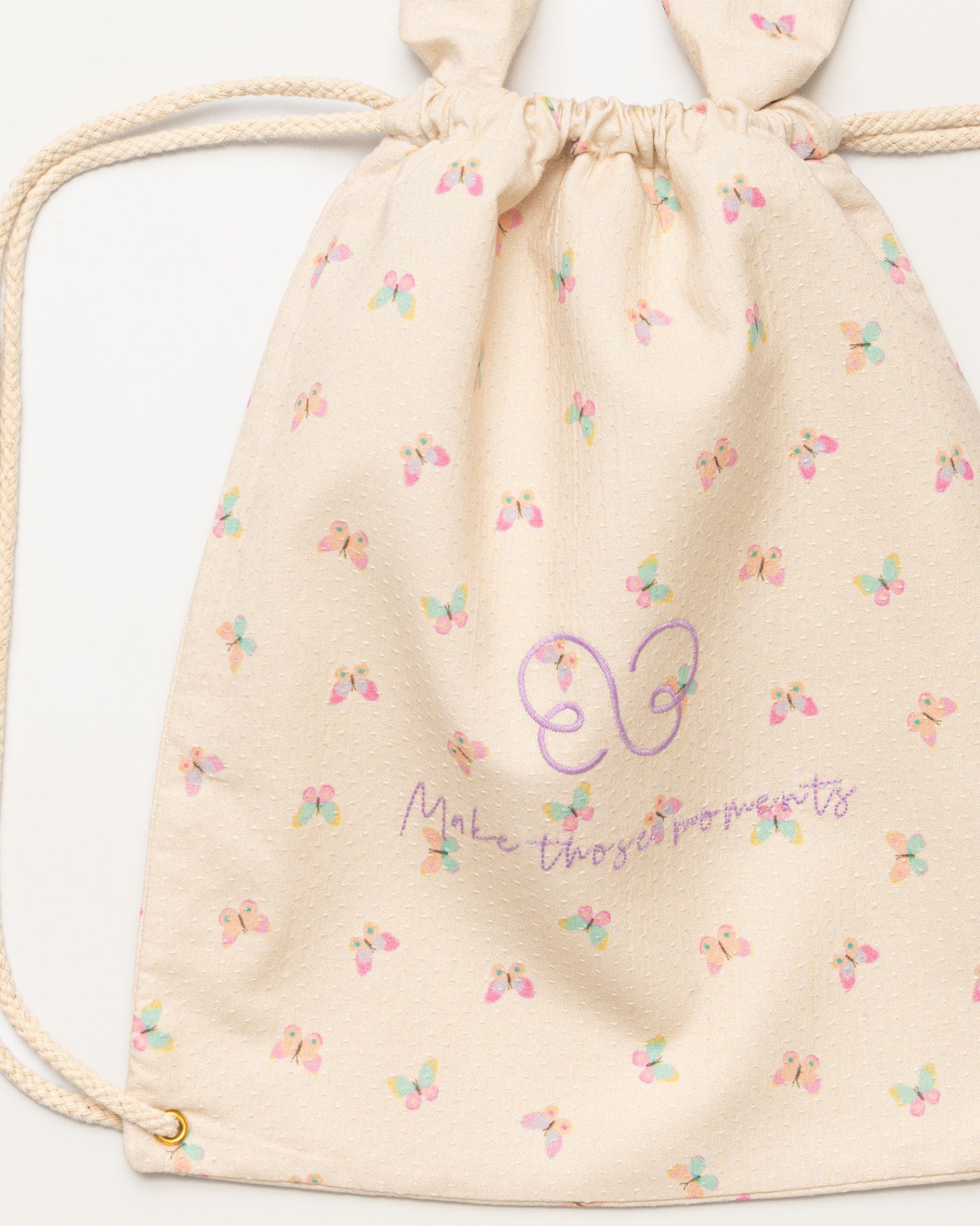 Early Sunday, Bunny Drawstring Backpack in Butterflies print, made from Printed Cotton Tiny Swiss Dobby fabric, featuring a bunny-ear design with a drawstring closure, shown in a closeup flat-lay view