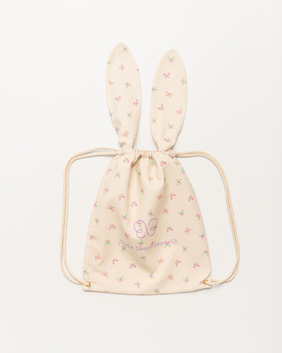 Early Sunday, Bunny Drawstring Backpack in Butterflies print, made from Printed Cotton Tiny Swiss Dobby fabric, featuring a bunny-ear design with a drawstring closure, shown in a front flat-lay view