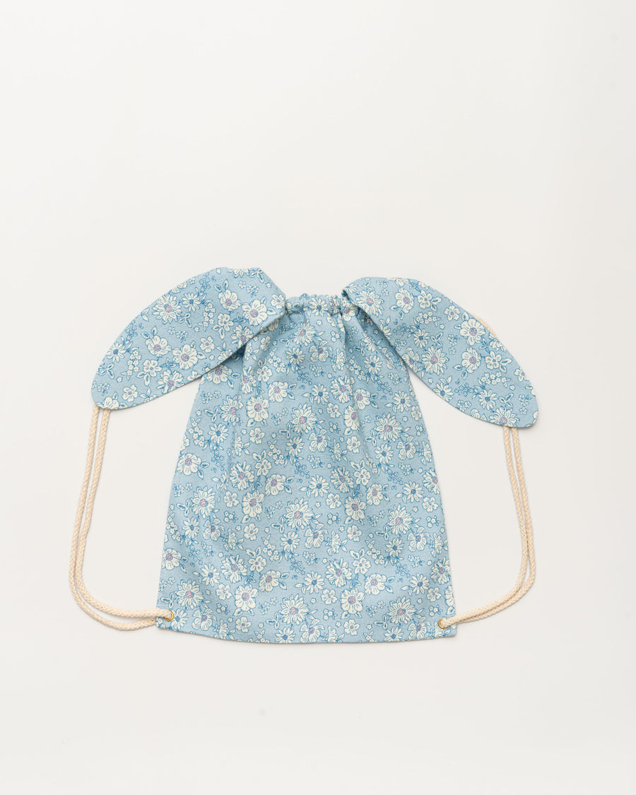Early Sunday, Bunny Drawstring Backpack in Tonal Floral Blue color, made from Printed Cotton Tiny Swiss Dobby fabric, featuring a bunny-ear design with a drawstring closure, shown in a back flat-lay view