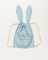 Early Sunday, Bunny Drawstring Backpack in Tonal Floral Blue color, made from Printed Cotton Tiny Swiss Dobby fabric, featuring a bunny-ear design with a drawstring closure, shown in a front flat-lay view