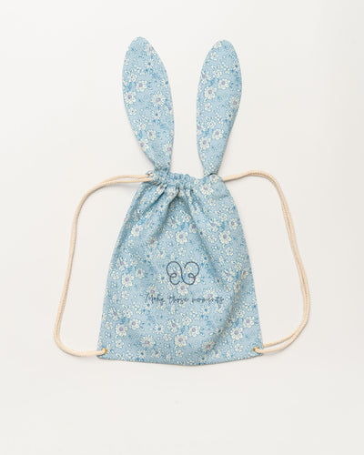 Early Sunday, Bunny Drawstring Backpack in Tonal Floral Blue color, made from Printed Cotton Tiny Swiss Dobby fabric, featuring a bunny-ear design with a drawstring closure, shown in a front flat-lay view