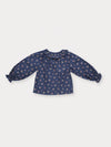 Early Sunday, Cécile Blouse in Ditsy Bouquet Navy, made from Printed Cotton Satin fabric, featuring a relaxed silhouette with gathered sleeves and delicate detailing, shown in a back flat-lay view
