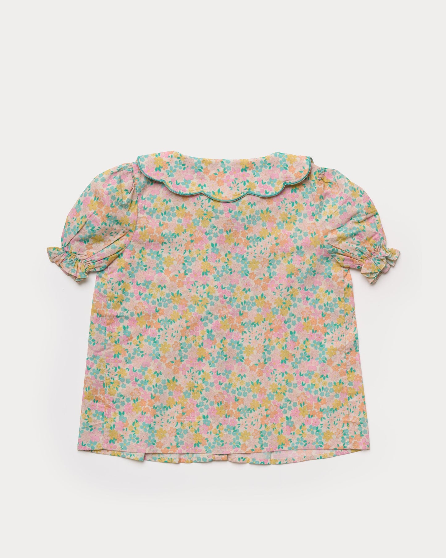 Early Sunday, Camelia Blouse in Emma Floral Mint color, made from printed 60s cotton cambric fabric, featuring short sleeves with peter pan collar, shown in a back flat-lay view