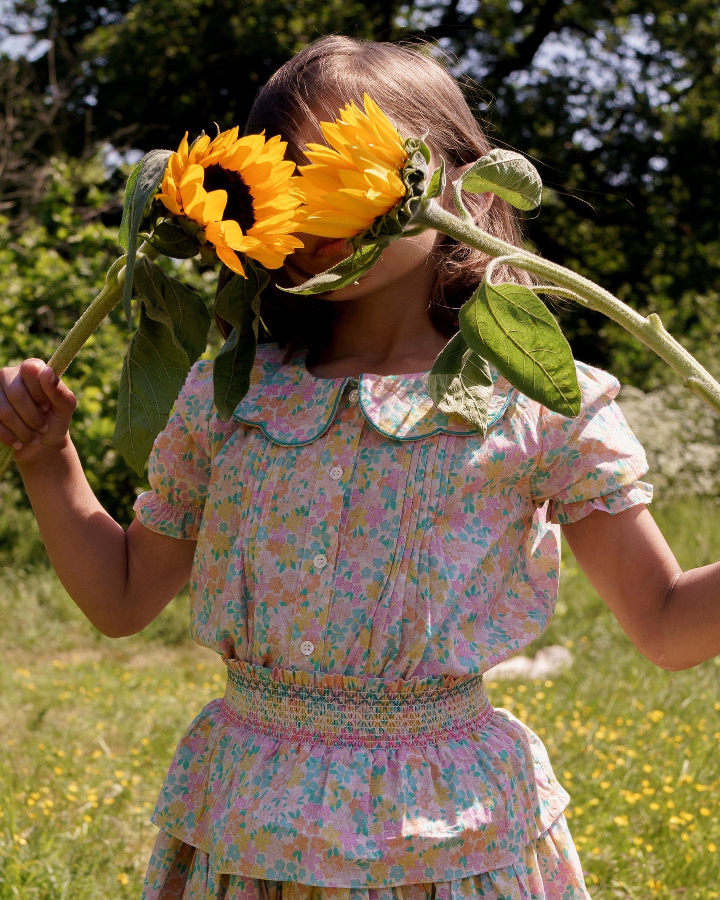 Early Sunday, Camelia Blouse in Emma Floral Mint color, made from printed 60s cotton cambric fabric, featuring short sleeves with peter pan collar, shown in a close up shot of model wearing it.