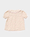 Early Sunday, Camelia Blouse in Butterfly Print color, made from printed cotton tiny swiss dobby fabric, featuring short sleeves with peter pan collar, shown in a back flat-lay view