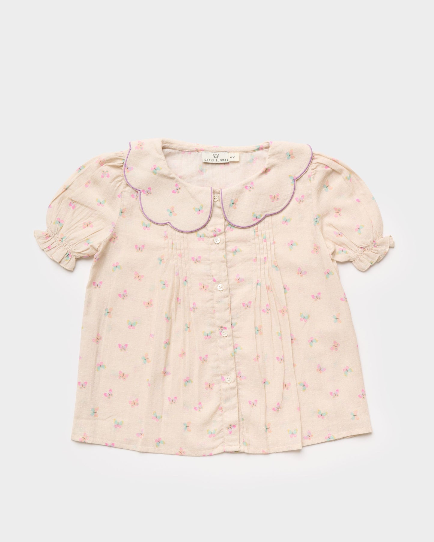 Early Sunday, Camelia Blouse in Butterfly Print color, made from printed cotton tiny swiss dobby fabric, featuring short sleeves with peter pan collar, shown in a front flat-lay view