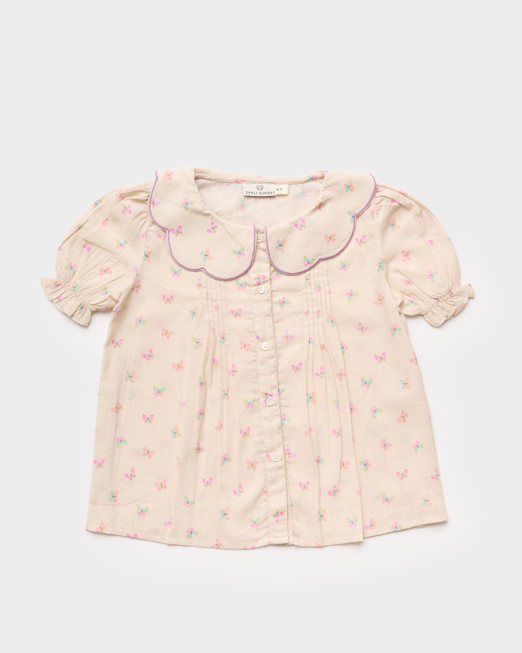 Early Sunday, Camelia Blouse in Butterfly Print color, made from printed cotton tiny swiss dobby fabric, featuring short sleeves with peter pan collar, shown in a front flat-lay view
