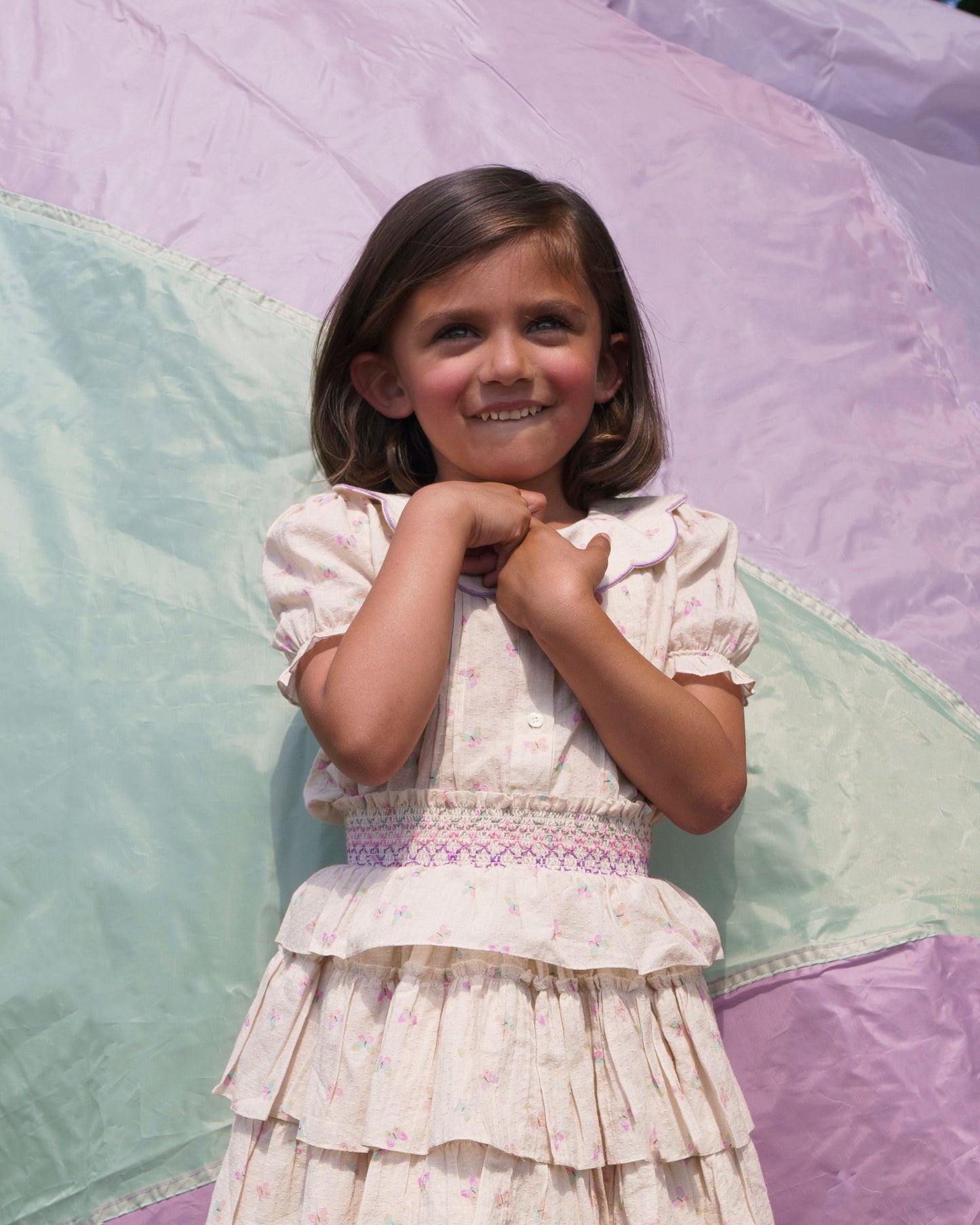 Early Sunday, Camelia Blouse in Butterfly Print color, made from printed cotton tiny swiss dobby fabric, featuring short sleeves with peter pan collar, shown in a front view of model wearing it