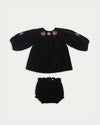 Early Sunday, Cara Baby Dress & Bloomer Set in Black, made from Cotton Velvet Velour's fabric, featuring a floral embroidery around the neckline with matching bloomer, shown in a front flat-lay view