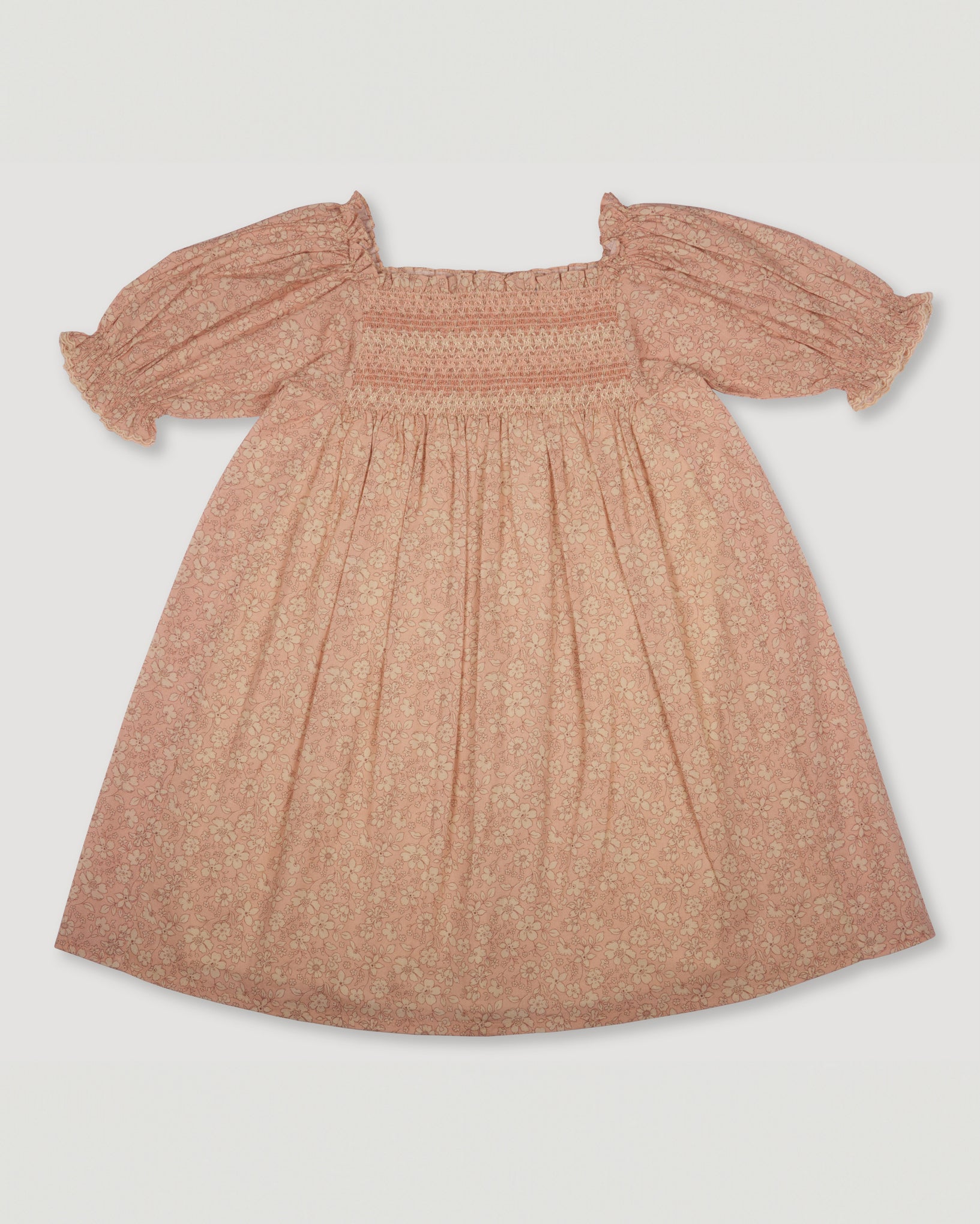 Early Sunday, Caroline Dress in Garden Flowers print color, made from Printed Cotton Cambric fabric, featuring tiered silhouette with thoughtful details for a feminine and relaxed look, shown in a back flat-lay view