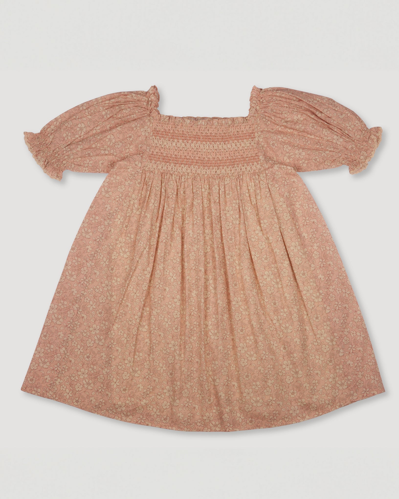 Early Sunday, Caroline Dress in Garden Flowers print color, made from Printed Cotton Cambric fabric, featuring tiered silhouette with thoughtful details for a feminine and relaxed look, shown in a front flat-lay view