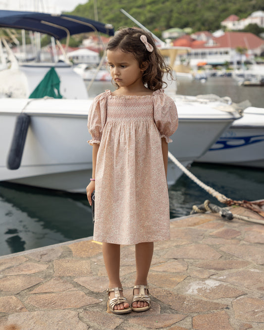 Early Sunday, Caroline Dress in Garden Flowers print, made from Printed Cotton Cambric fabric, featuring tiered silhouette with thoughtful details for a feminine and relaxed look, shown in a front view of model wearing it