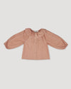 Early Sunday, Cecilia Blouse in Earthy Pink color, made from Cotton Swiss Dobby fabric, featuring relaxed fit, frill neckline, long sleeves with elasticated cuffs, and MOP buttons, shown in a front flat-lay view