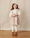Early Sunday, Cecilia Blouse in Ecru print, made from Cotton Swiss Dobby fabric, featuring relaxed fit, frill neckline, long sleeves with elasticated cuffs, and MOP buttons, shown in a front view of model wearing it