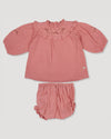 Early Sunday, Charlie Baby Dress & Bloomer Set in Rose color, made from Dyed Cotton Double Gauze fabric, featuring ruffled neckline with floral embroidery & matching bloomers, shown in a front flat-lay view