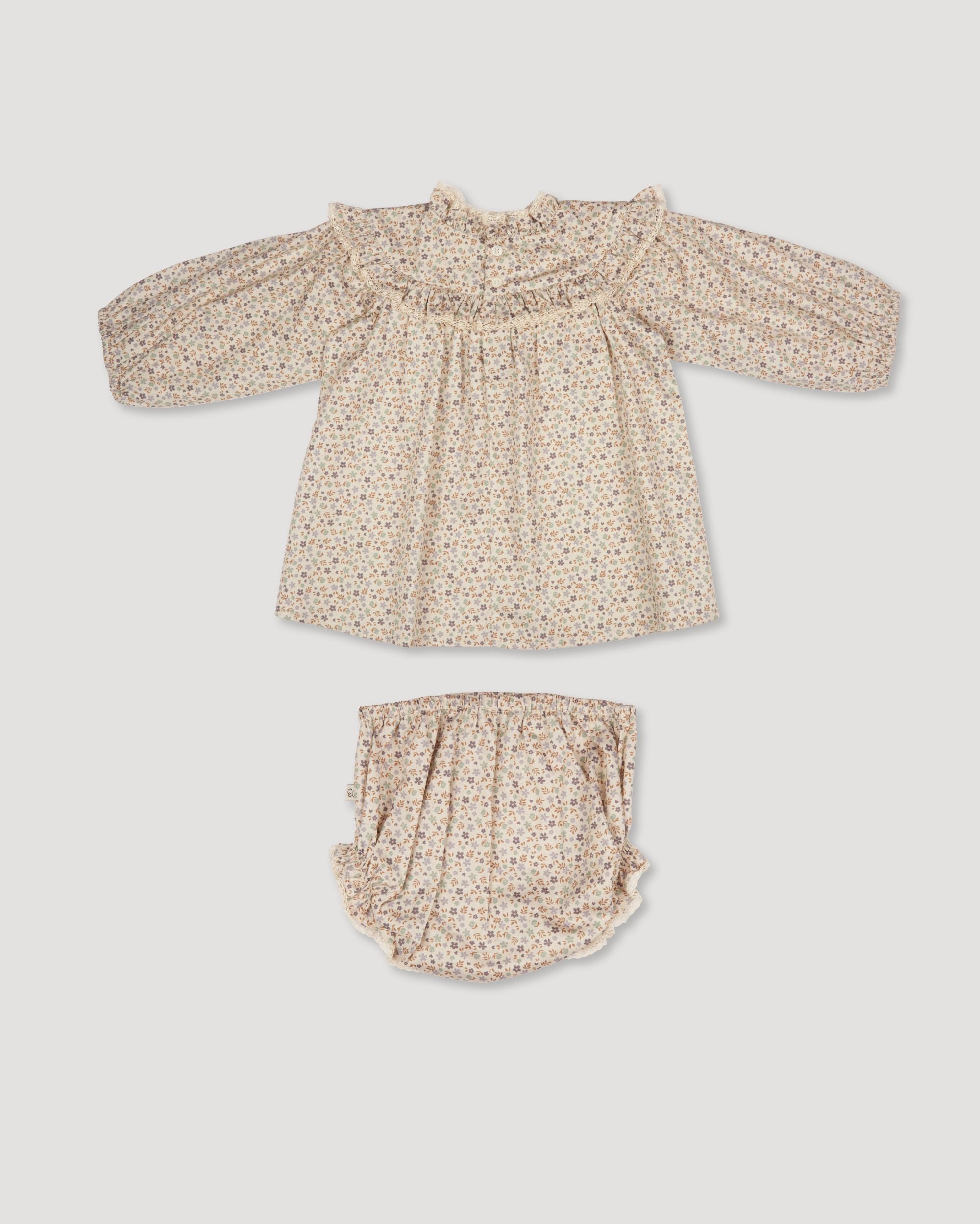 Early Sunday, Charlie Baby Dress & Bloomer Set in Mini Flowers print, made from Printed 60s Cotton Satin fabric, featuring long sleeves with rufflled lace & matching bloomers, shown in a back flat-lay view