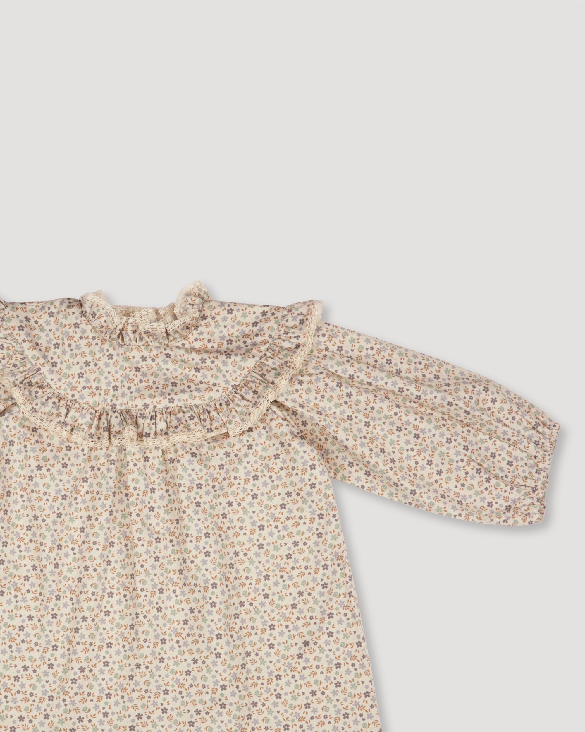 Early Sunday, Charlie Baby Dress & Bloomer Set in Mini Flowers print, made from Printed 60s Cotton Satin fabric, featuring long sleeves with rufflled lace & matching bloomers, shown in a closeup flat-lay view