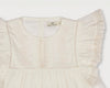 Early Sunday, Charlie Blouse in Ivory color, made from Cotton Tiny Swiss Dots fabric, featuring Flutter sleeves, pintuck detailing, and a flowy, gathered silhouette, shown in a closeup flat-lay view