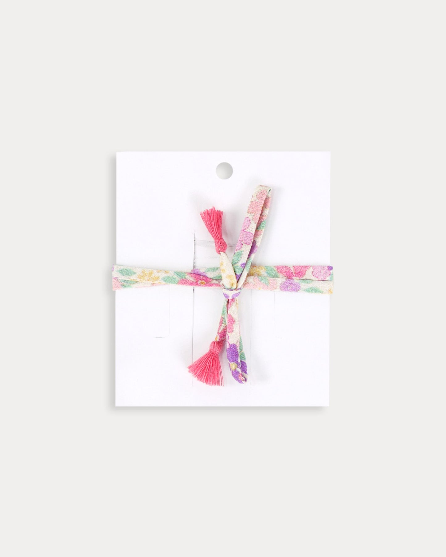 Early Sunday, Charm Bracelet in Emma Floral Purple color, made from Organic Printed Cotton Cambric fabric, featuring a soft fabric bracelet design with a charm, shown in a back flat-lay view