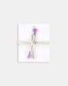 Early Sunday, Charm Bracelet in Painted Bouquet print, made from Printed 70% Cotton, 30% Linen fabric, featuring a soft fabric bracelet design with a charm, shown in a back flat-lay view