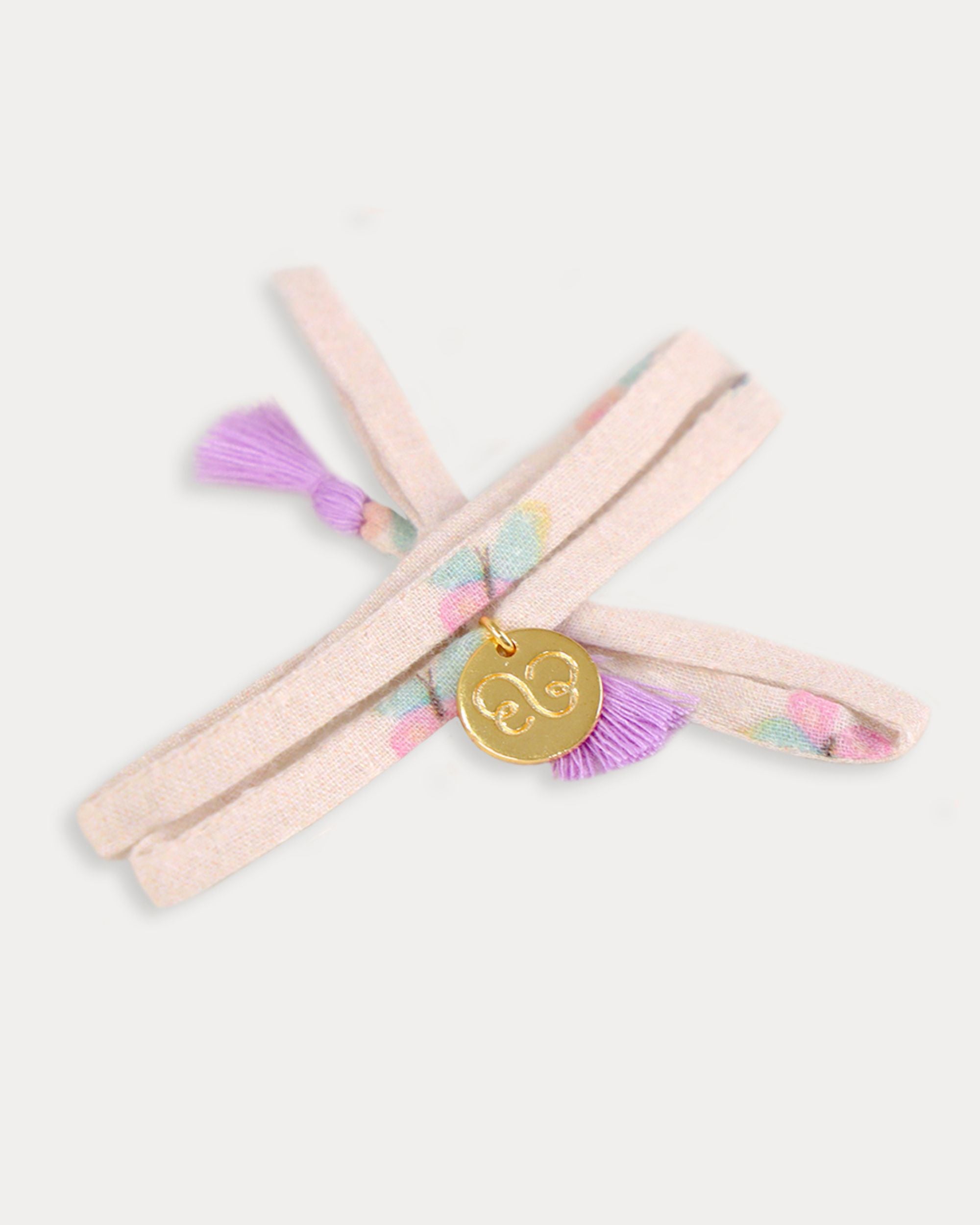 Early Sunday, Charm Bracelet in Butterflies print, made from Printed Cotton Tiny Swiss Dobby fabric, featuring a soft fabric bracelet design with a charm, shown in an angled view with a close-up shot