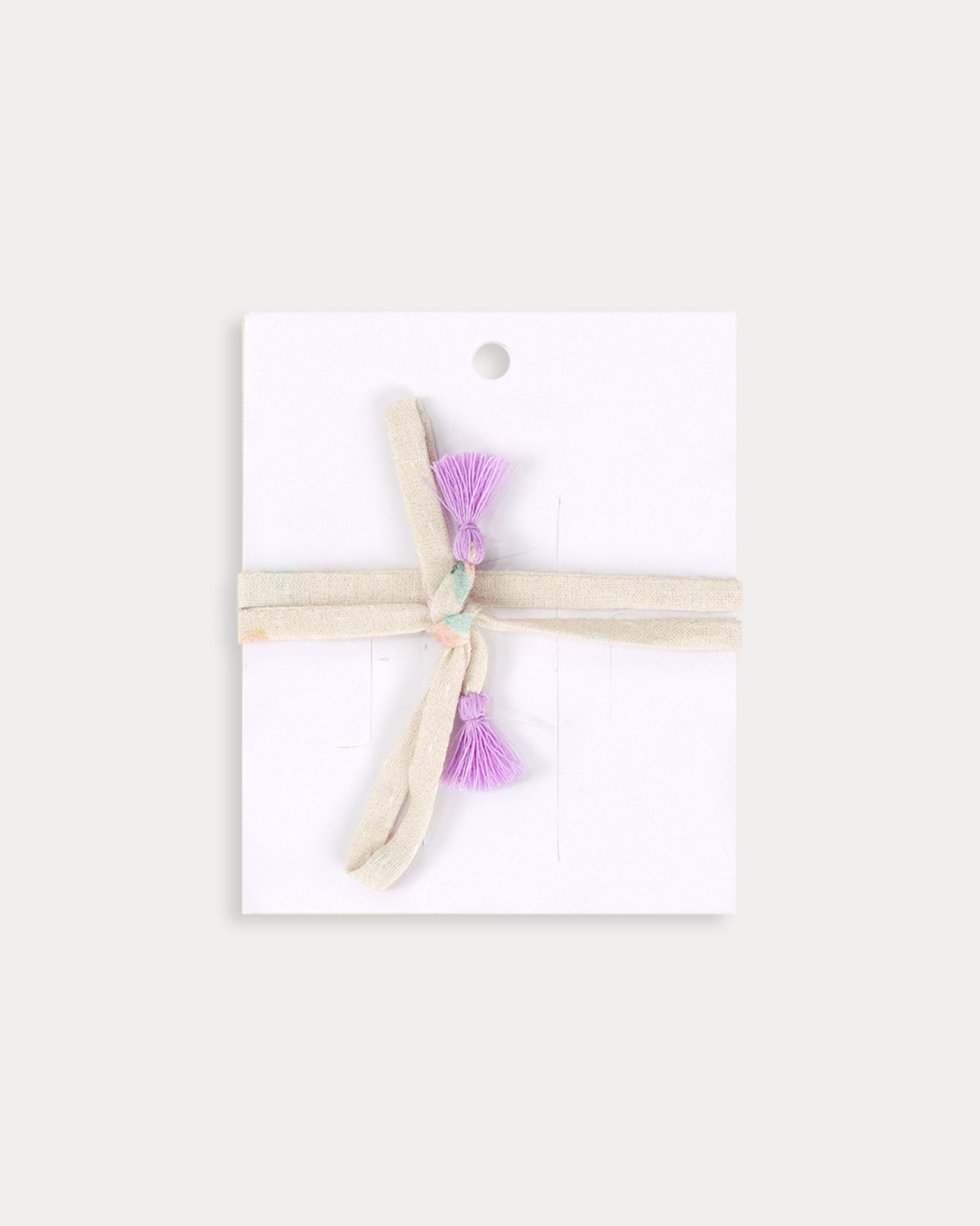Early Sunday, Charm Bracelet in Butterflies print, made from Printed Cotton Tiny Swiss Dobby fabric, featuring a soft fabric bracelet design with a charm, shown in a back flat-lay view