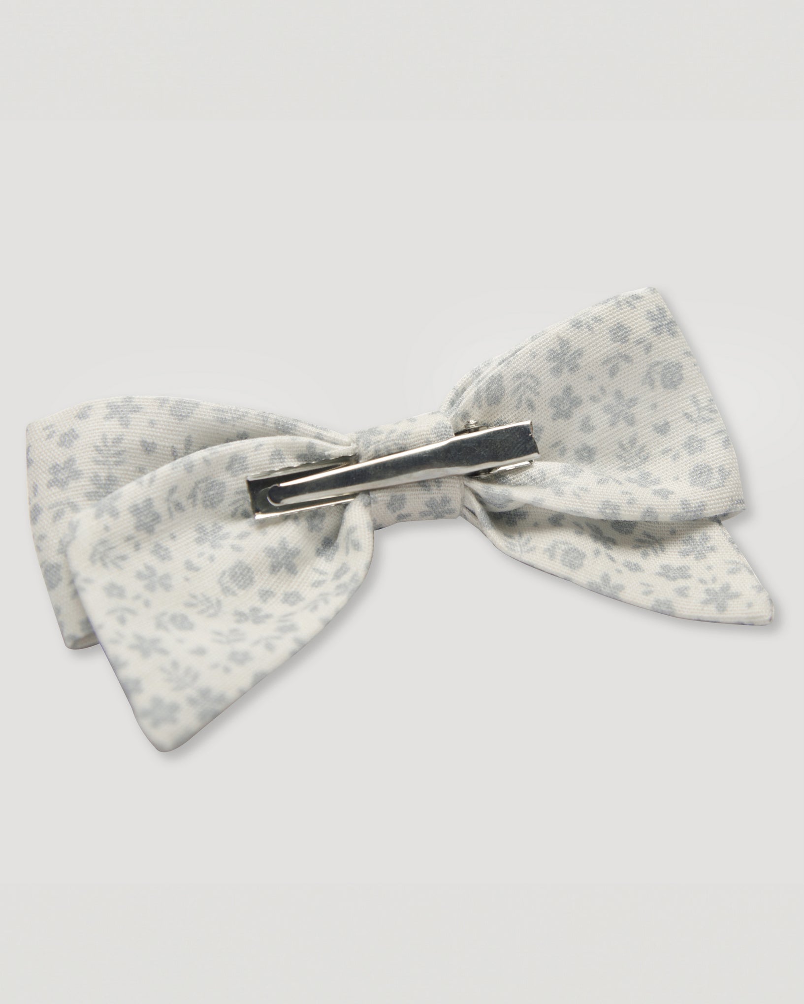 Early Sunday, Chiara Alligator Clip in Mini Flower print, made from Printed Cotton Cambric fabric, featuring a bow design on an alligator clip with a secure fit, shown in a back flat-lay view