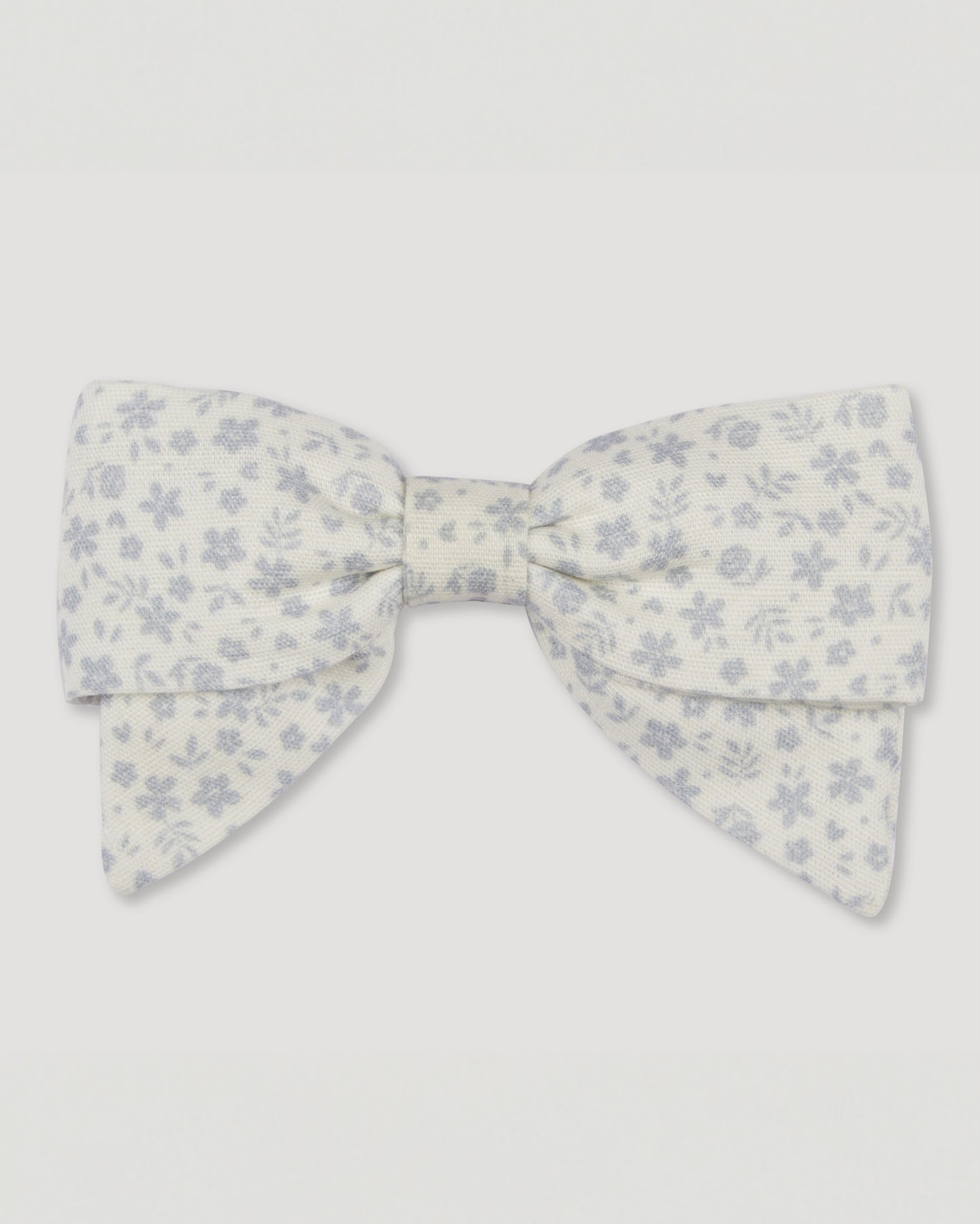 Early Sunday, Chiara Alligator Clip in Mini Flower print, made from Printed Cotton Cambric fabric, featuring a bow design on an alligator clip with a secure fit, shown in a front flat-lay view