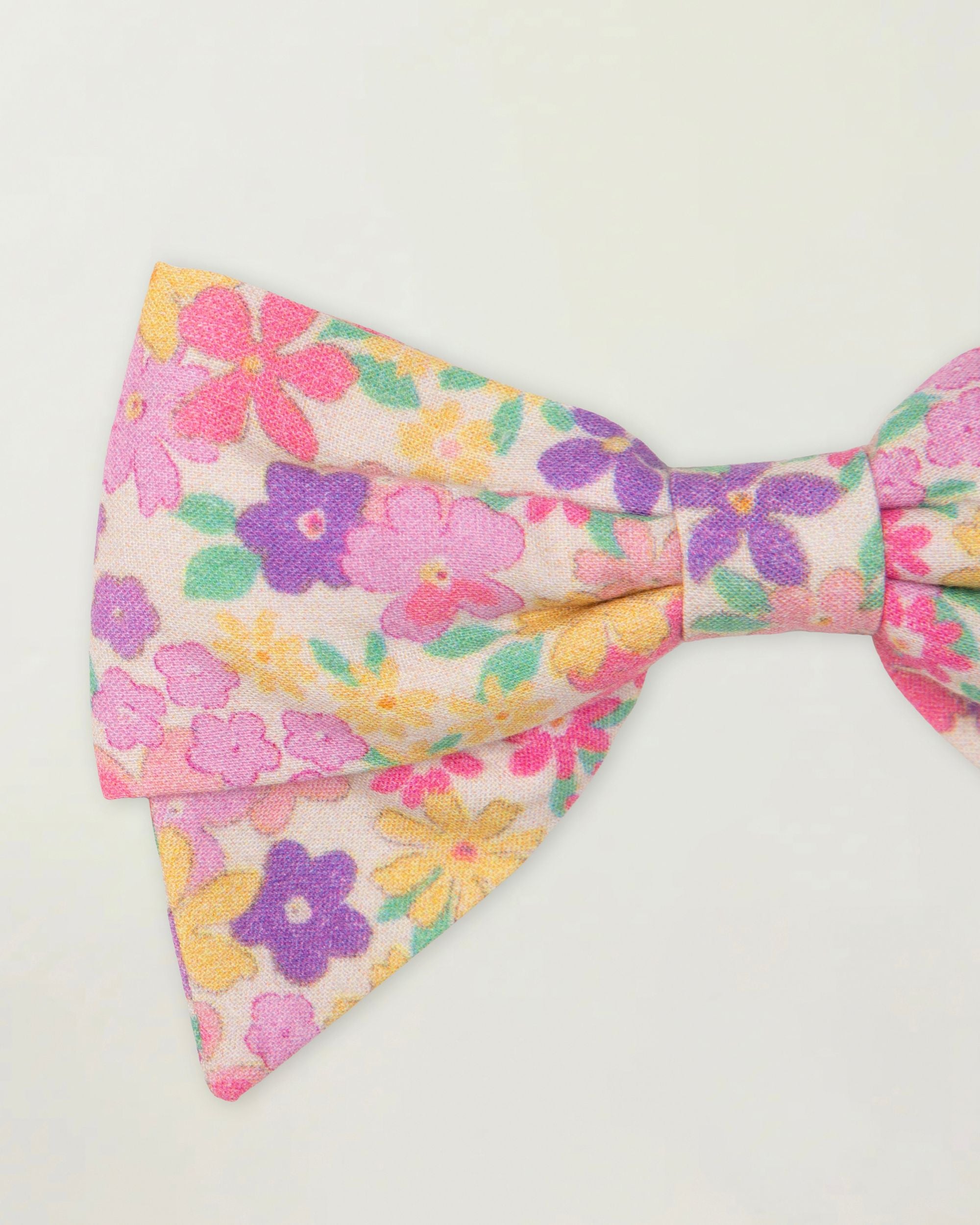 Early Sunday, Chiara Clip in Emma Floral Purple color, made from Organic Printed Cotton Cambric fabric, featuring a bow design on an alligator clip with a secure fit, shown in closeup flat-lay view