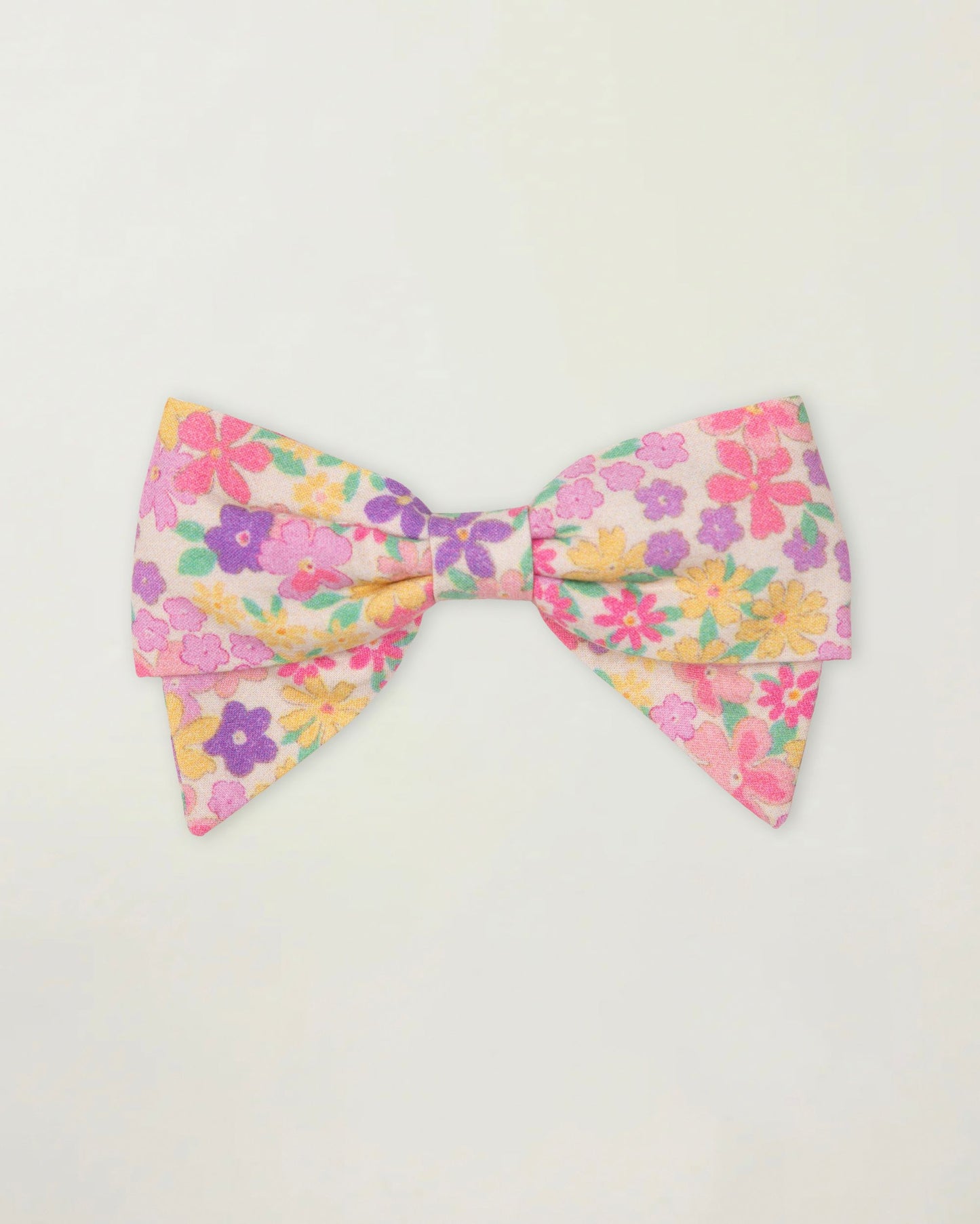 Early Sunday, Chiara Clip in Emma Floral Purple color, made from Organic Printed Cotton Cambric fabric, featuring a bow design on an alligator clip with a secure fit, shown in front flat-lay view