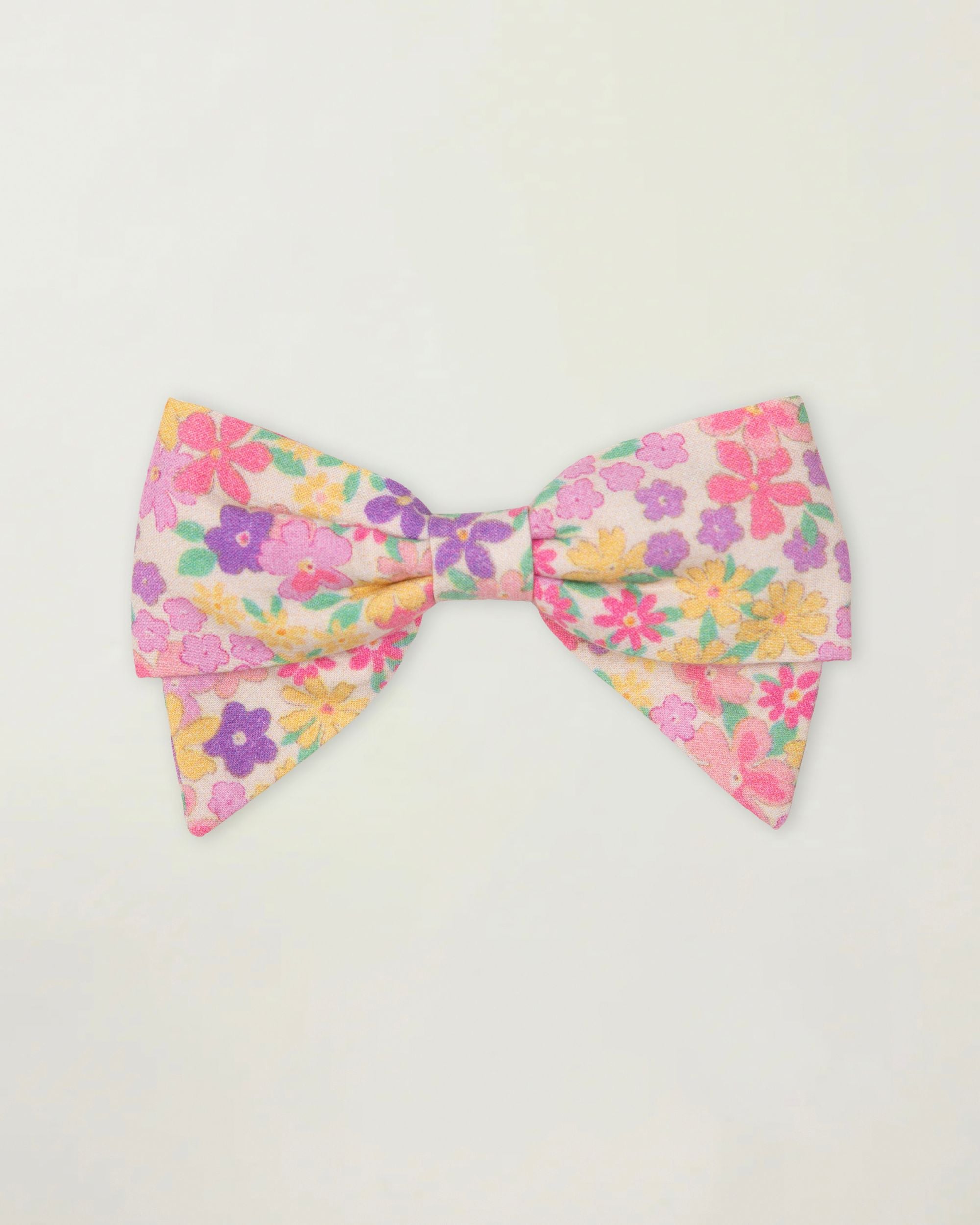 Early Sunday, Chiara Clip in Emma Floral Purple color, made from Organic Printed Cotton Cambric fabric, featuring a bow design on an alligator clip with a secure fit, shown in front flat-lay view
