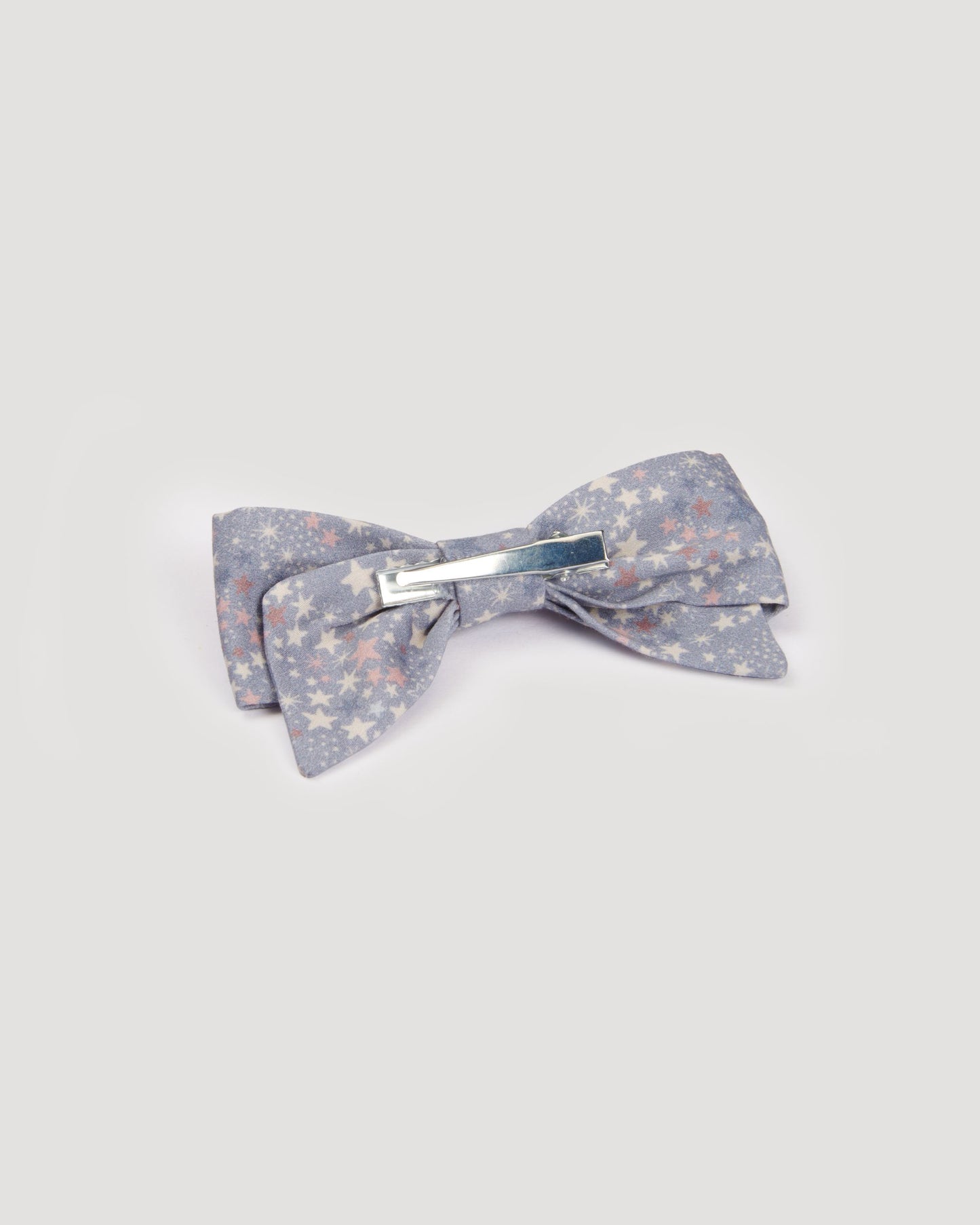Early Sunday, Chiara Clip in Celestial print, made from Printed 60s Cotton Satin fabric, featuring a bow design on an alligator clip with a secure fit, shown in a back flat-lay view