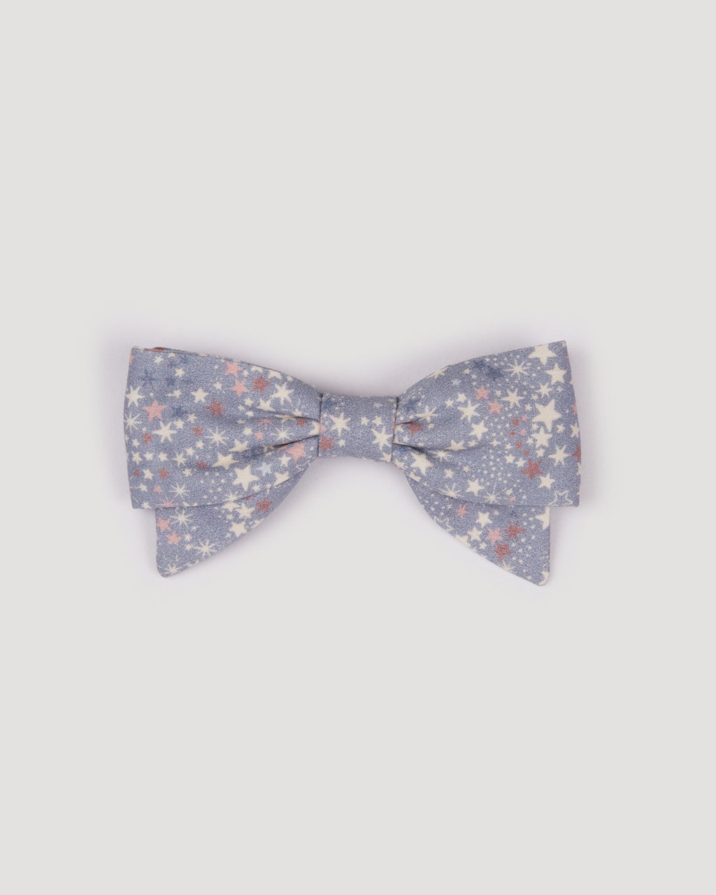 Early Sunday, Chiara Clip in Celestial print, made from Printed 60s Cotton Satin fabric, featuring a bow design on an alligator clip with a secure fit, shown in a front flat-lay view