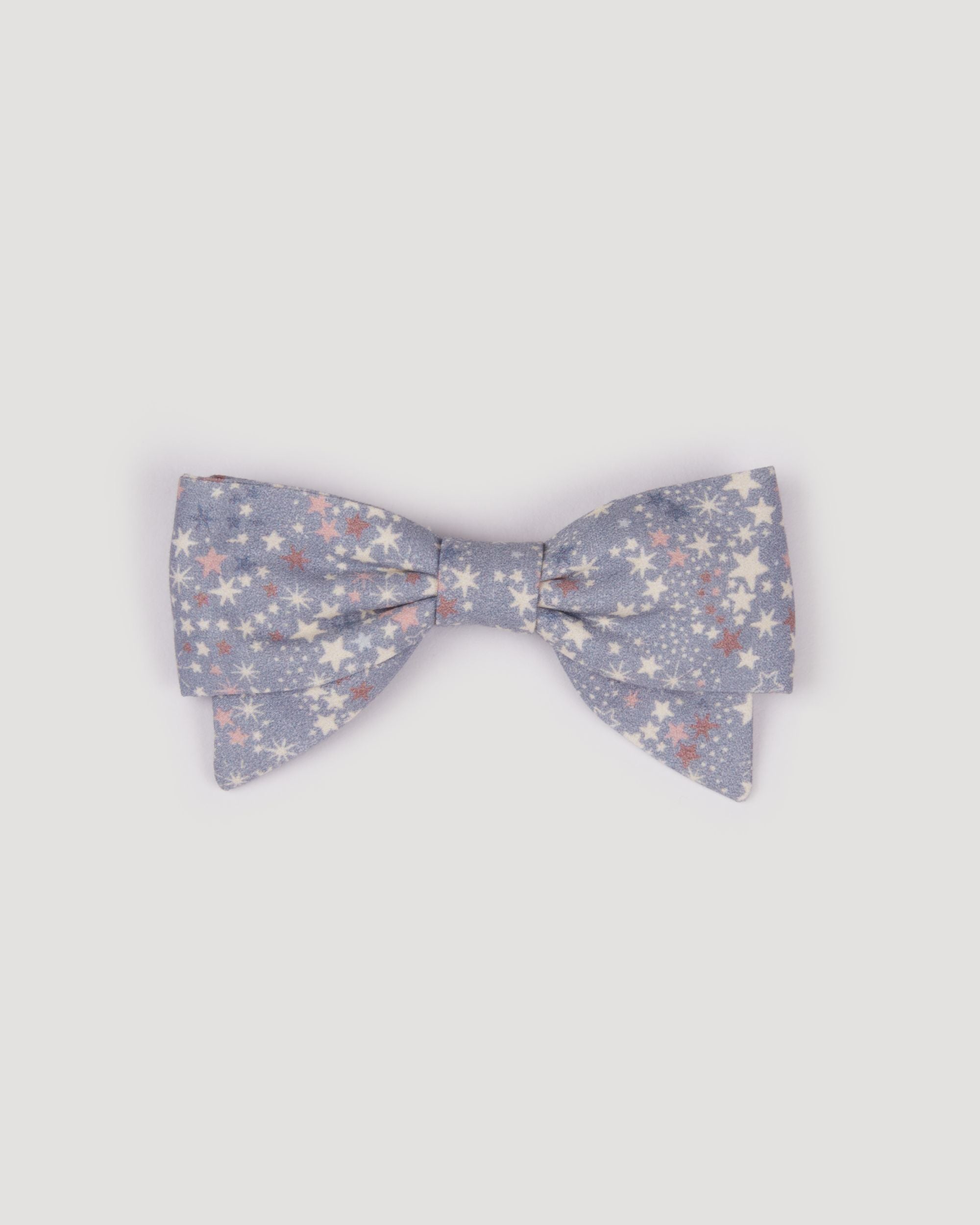 Early Sunday, Chiara Clip in Celestial print, made from Printed 60s Cotton Satin fabric, featuring a bow design on an alligator clip with a secure fit, shown in a front flat-lay view