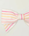Early Sunday, Chiara Clip in Pink Stripes print, made from Printed 70% Cotton, 30% Linen fabric, featuring a bow design on an alligator clip with a secure fit, shown in a closeup flat-lay view