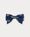 Early Sunday, Chiara Clip in Ditsy Bouquet Navy Blue, made from Printed Cotton Satin fabric, featuring a bow design on an alligator clip with a secure fit, shown in a back flat-lay view