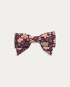 Early Sunday, Chiara Clip in Garden Flowers Plum, made from Printed Cotton Satin fabric, featuring a bow design on an alligator clip with a secure fit, shown in a front flat-lay view