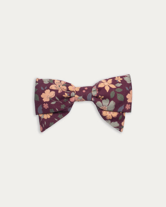 Early Sunday, Chiara Clip in Garden Flowers Plum, made from Printed Cotton Satin fabric, featuring a bow design on an alligator clip with a secure fit, shown in a front flat-lay view