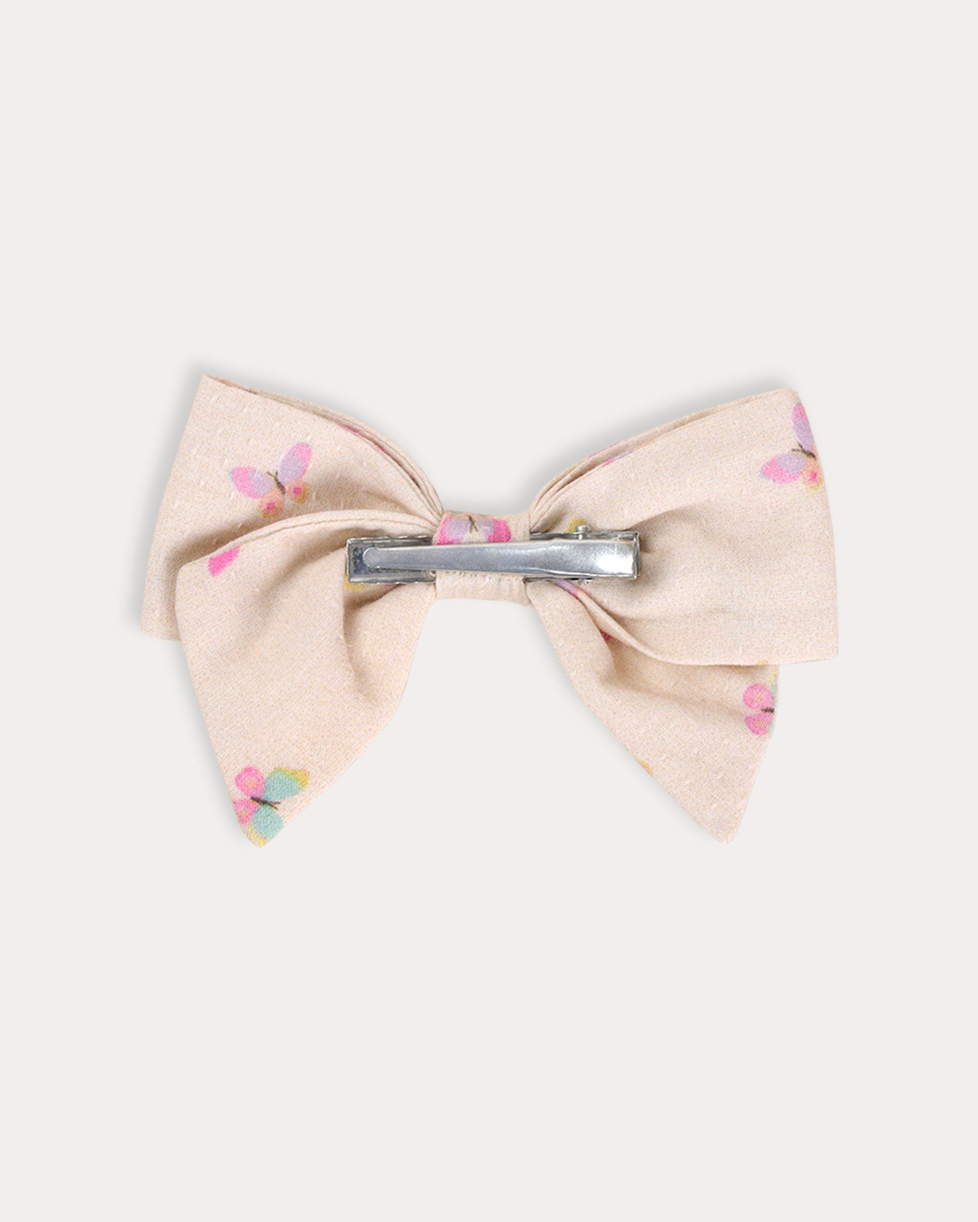 Early Sunday, Chiara Clip in Butterflies print, made from Printed Cotton Tiny Swiss Dobby fabric, featuring a bow design on an alligator clip with a secure fit, shown in a back flat-lay view