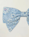 Early Sunday, Chiara Clip in Tonal Floral Blue color, made from Printed Cotton Tiny Swiss Dobby fabric, featuring a bow design on an alligator clip with a secure fit, shown in a closeup flat-lay view